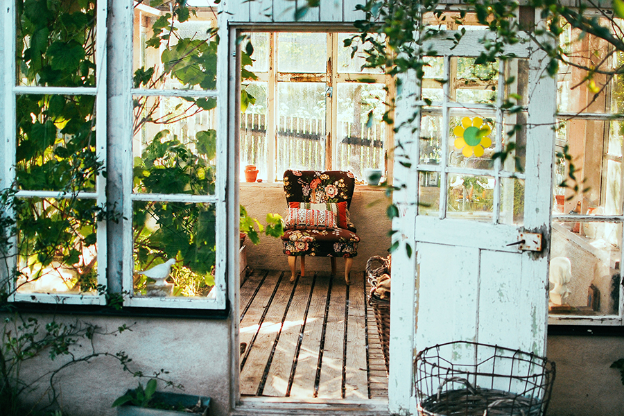 Rustic Greenhouse with an arm chair inside