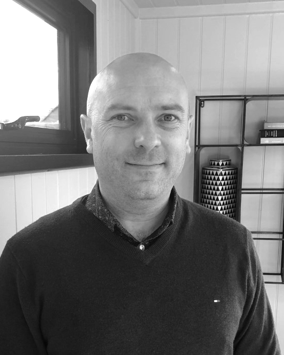 A black and white headshot of David who is smiling. David works as part of our sales team at our Buckinghamshire showsite