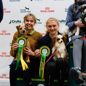 Martha and Maxwell with rosettes at Crufts 2022