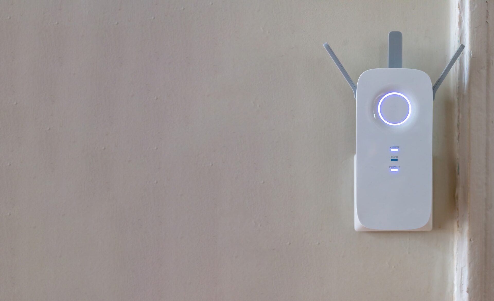 White internet powerline adapter plugged into walk socket. Providing expended wifi coverage.