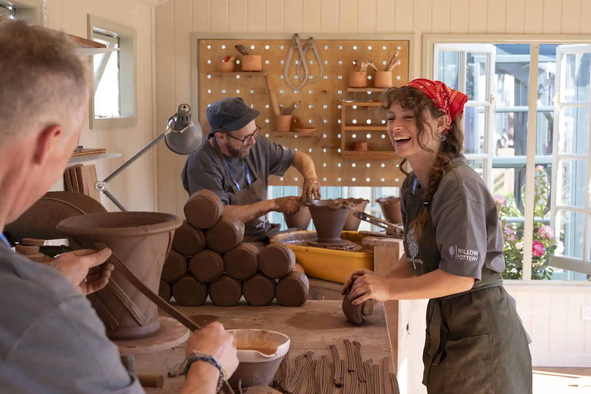 Matt Pasmore of Willow Pottery wokring inside studio with team