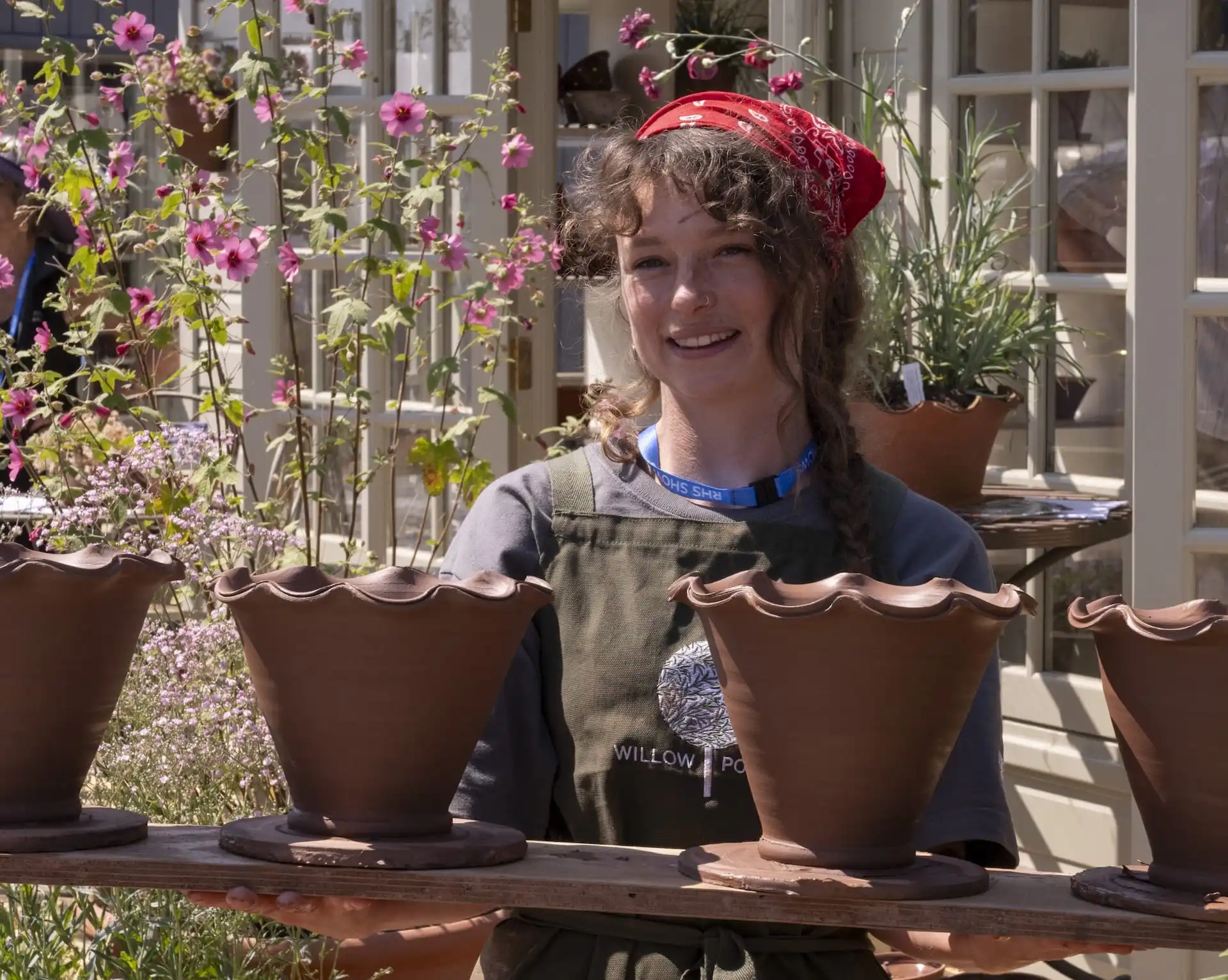 Willow Pottery team member holding pottery