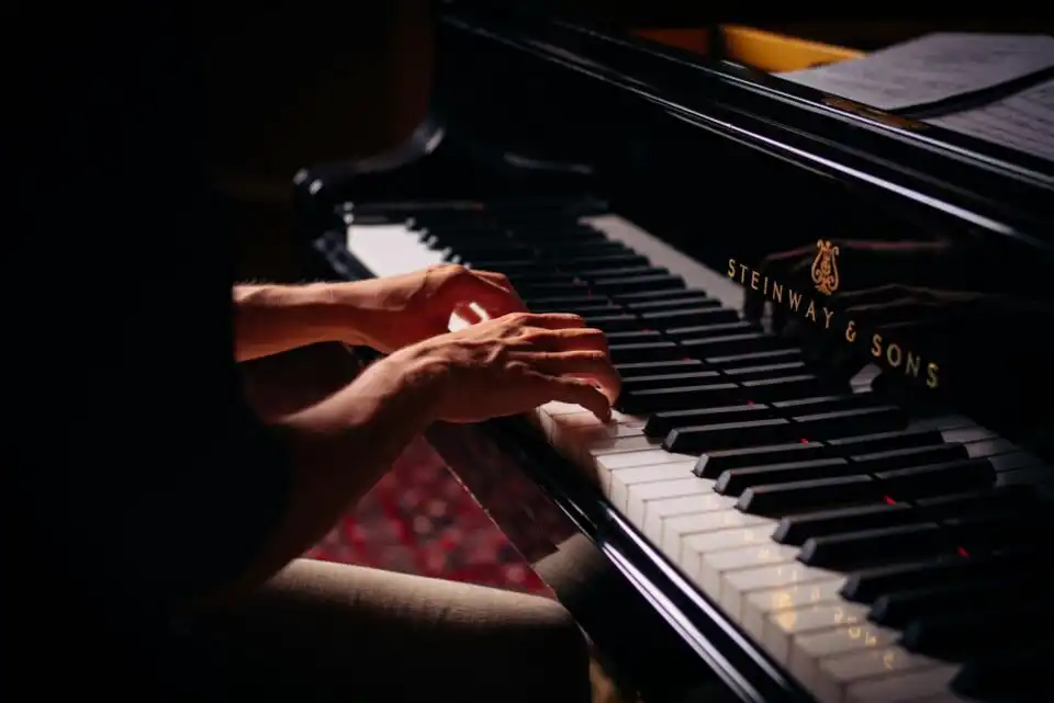 a jazz pianist playing a steinway piano