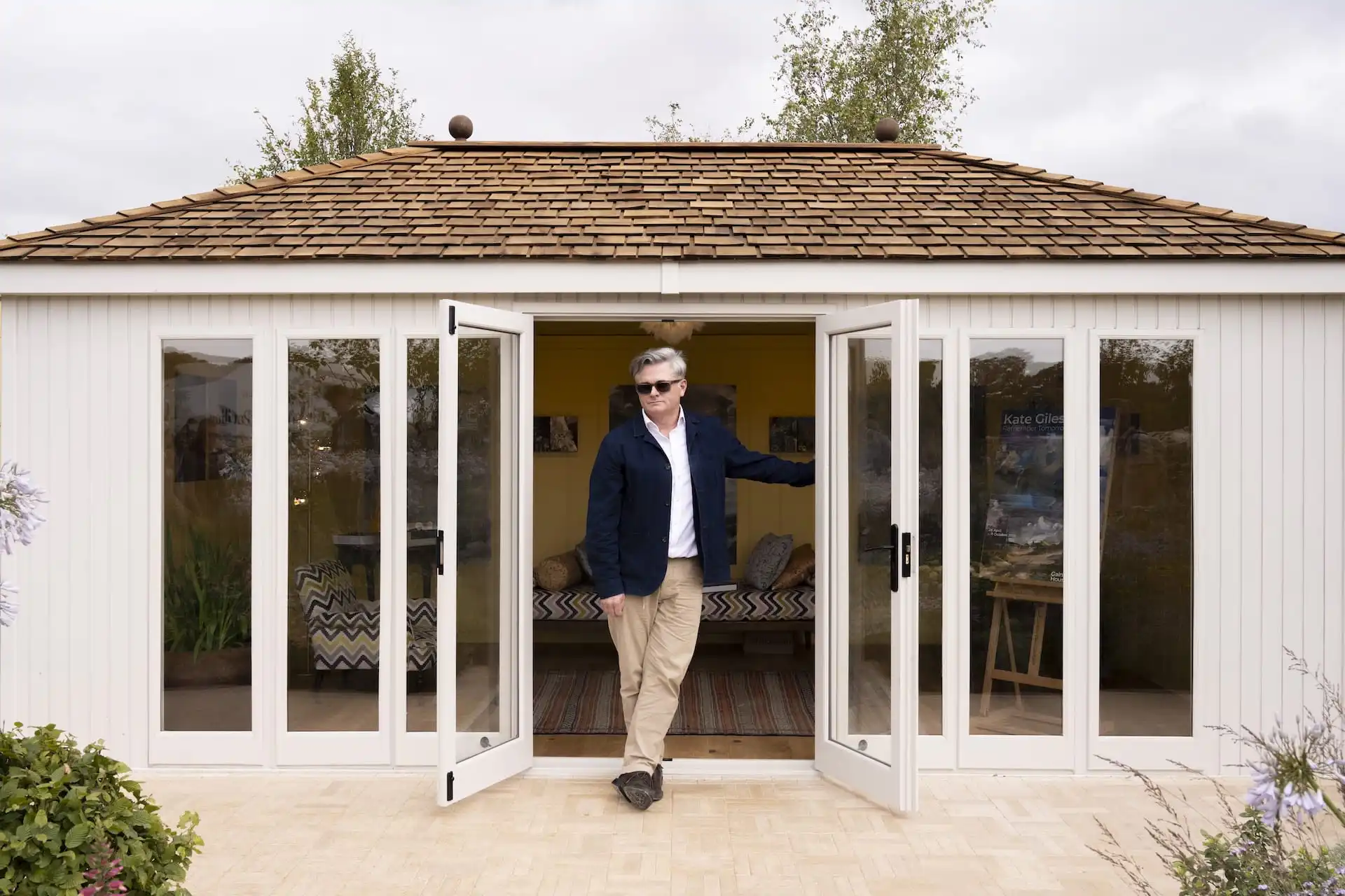 central view of man standing in open doorway of malvern garden buildings studio hipped at RHS Sandringham