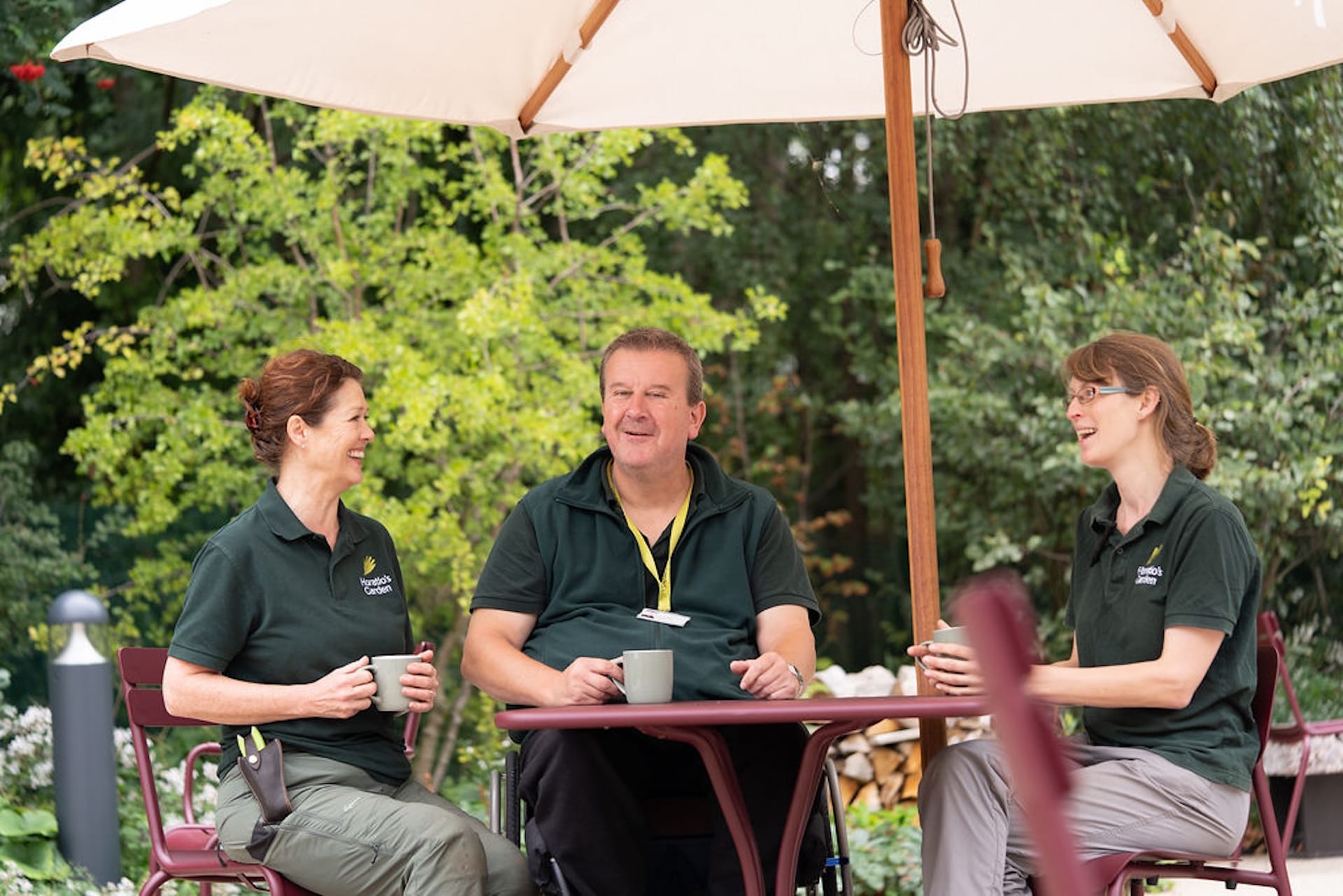 group of volunteers sitting around table inside horatios garden