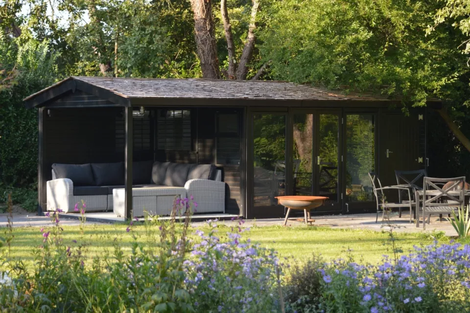 studio pavillion in grass garden with seating and fire pit