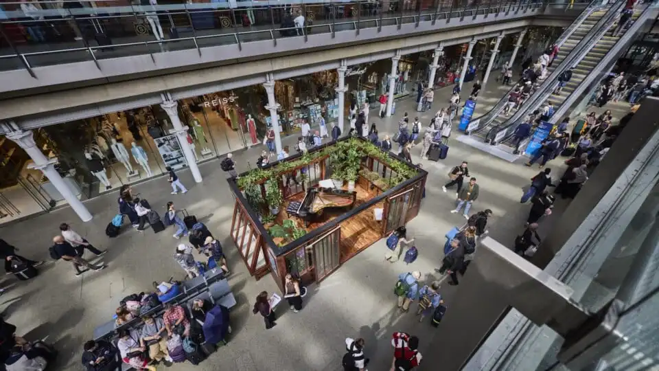 top view of composers cabin on display at st pancras with people moving through the platform